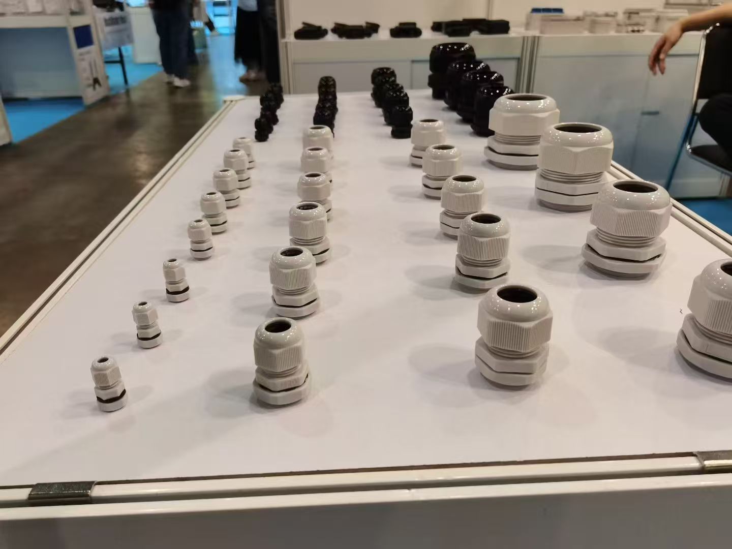 White and black nylon cable glands on display